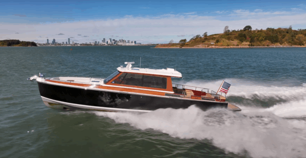 Boston Boat Works 48’ Daychaser cruising at speed with the Boston skyline visible in the distance.