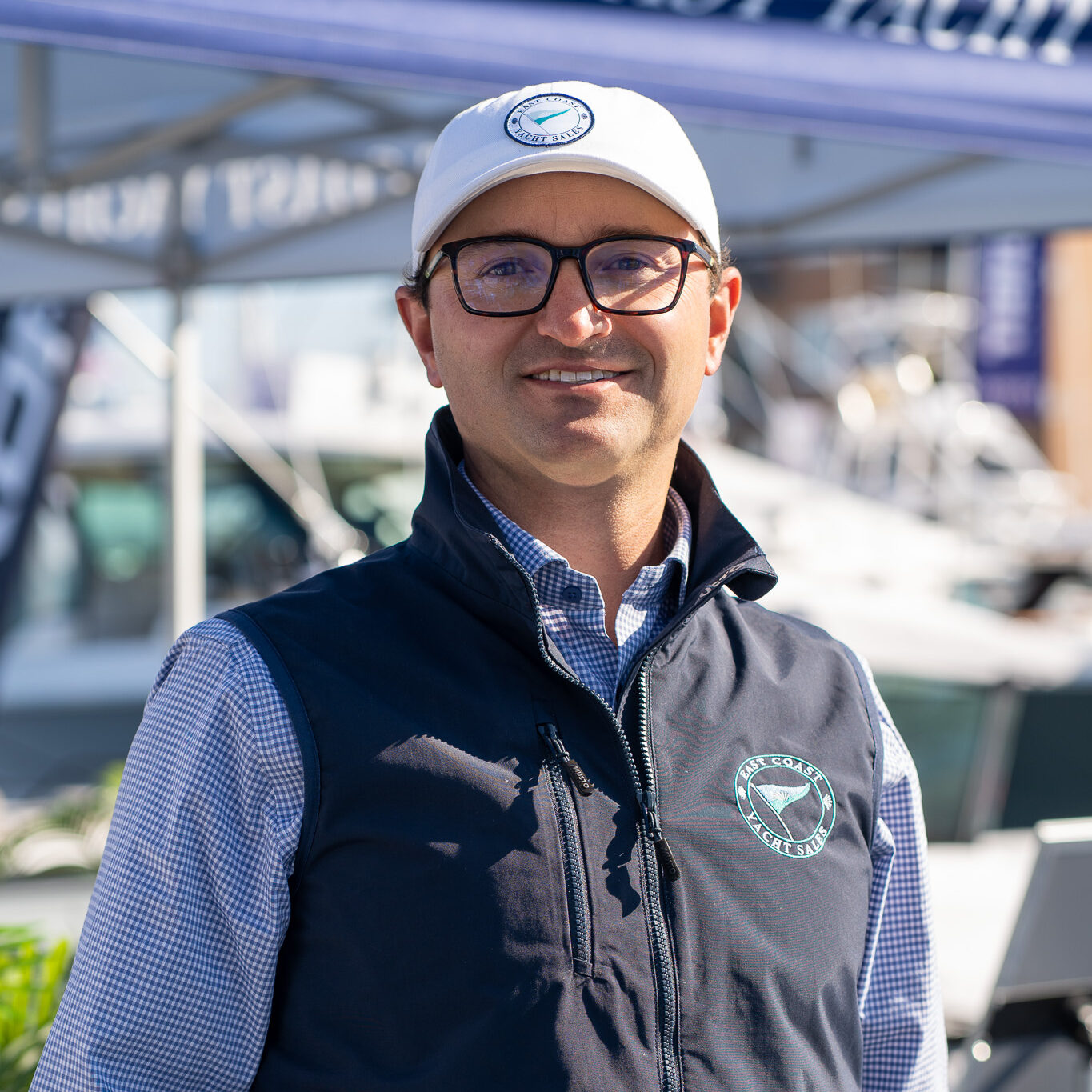 Ben Knowles – President & Owner, East Coast Yacht Sales Headshot of Ben Knowles, President and Owner of East Coast Yacht Sales, taken at the Newport International Boat Show 2025 with the East Coast Yacht Sales tent in the background.