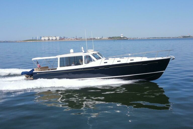 MJM 50z – East Coast Yacht Sales MJM 50z cruising on calm water with glass-like reflections.