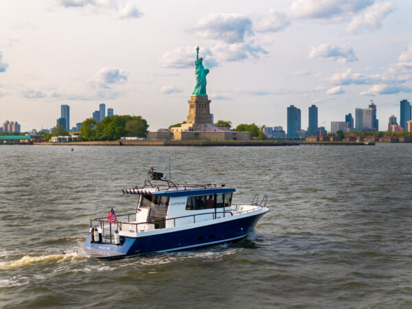 Targa 37 in New York Harbor – East Coast Yacht Sales Targa 37 cruising in New York Harbor with the Statue of Liberty in the background.