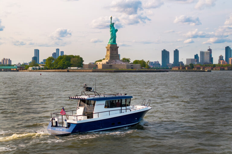 Targa 37 in New York Harbor – East Coast Yacht Sales Targa 37 cruising in New York Harbor with the Statue of Liberty in the background.