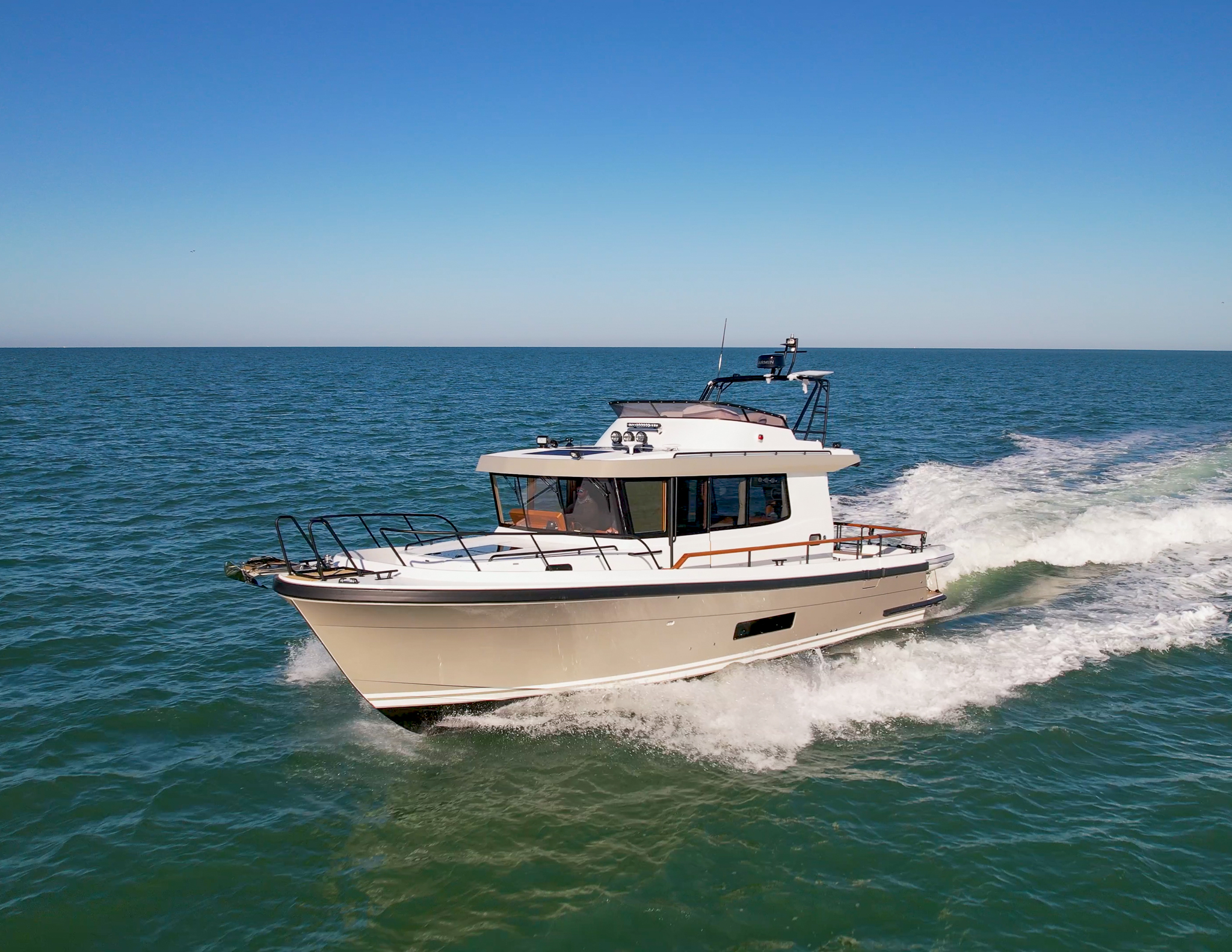 Targa 41 with a light gray hull cruising through blue-green ocean off the coast of New England.