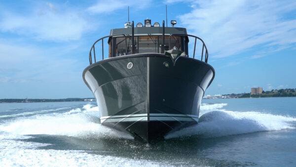 Targa 32 Cruising in Casco Bay – Portland, Maine Targa 32 with green hull cruising head-on in Casco Bay, Portland, Maine, with the Eastern Promenade visible in the distance.